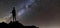 Back view of young slim backpacker tourist girl on rocky mountain top on dark night starry sky and foggy mountain range panorama