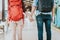 Back view of young traveler couple with backpack holding hand at train station