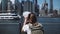 Back view young traveler girl looking through coin binoculars at epic panorama of Manhattan financial center, New York.