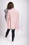 Back view of young woman in casual wear holding pink a turtleneck sweater isolated on white. Fashion clothes  streetstyle concept