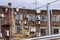 Back wall of a brick building with hanging air conditioners.