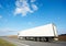 Back of white lorry trailer over blue sky