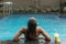 Back of woman with fuit shake in pool