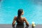 Back of woman with fuit shake in pool