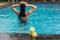 Back of woman with fuit shake in pool