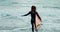 Back, woman and running into ocean with surfboard at beach, ready for fitness in wet suit, sports and surfing in nature