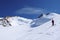 Backcountry skier admires the view of the Monte Rosa mountains and glaciers in the Swiss Alps above Zermatt