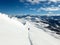 Backcountry skier enjoying a deep powder ski descent in the high Alps of Switzerland in deep winter near Arosa