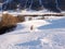 Backcountry skier in fresh powder skiing to the valley bottom through forest in the winter in the Swiss Alps