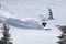 backcountry skier gracefully carves through the untouched powder snow, leaving behind a trail of white fluff in their wake
