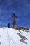 Backcountry skier and mountain climber on the summit of Corno Nero in the Alps of Italy on a winter day