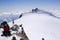 Backcountry skier and mountain climber on the summit of Zumsteinspitze in the Alps of Switzerland on a winter day