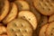 Backdrop of pile of golden round butter crackers