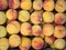 Backdrop of stacked yellow peaches