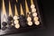 Backgammon. Board game. White cubes and chips on a blackboard.  Dice on backgammon board game. Selective focus. Playing leisure