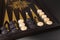 Backgammon. Board game. White cubes and chips on a blackboard.  Dice on backgammon board game. Selective focus. Playing leisure