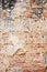 Background abstract weathered wall exposing brick structure