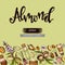 Background with almond, essential oils, flowers and lettering almond