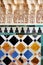 Background of arab tiles and plasterwork, islamic art. Palace of Alhambra in Granada, Andalusia, Spain