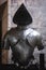 Background with armour of the medieval knight. Metal protection of the soldier. Steel Plate. Rivets and engraving, dark light