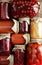 Background from assorted of canned vegetables and fruits- food in plastic free jars on wooden rustic table, flat lay,