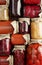 Background from assortment of canned vegetables and fruits- food in plastic free jars on wooden rustic table, flat lay