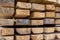 Background base stack of boards end face storage of building materials natural material light pattern