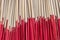 Background of beige incense sticks with red holders