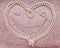 Background beige with white pearls heart for valentine`s day