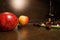 Background of big apples and dark cherries on the kitchen table