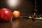Background of big apples and dark cherries on the kitchen table