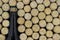 Background of black champagne bottle surrounded of many champagne corks