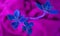 A background of blue flower petals, a beautiful flower wrapped in cloth. Ikebana in pink fabric. Decorative colorful flower