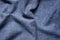 Background Of Blue Gray Crumpled Jeans Cloth.