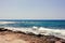 Background of blue sea. Rocky coast of the sea. Mediterranean sea in Cyprus. Nature background. Blue lagoon. Sea shore with summer