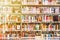 The background blurred Image many books on bookshelf in library and orange leak light