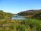 Background blurred landscape view of the hills and water of the isthmus between the fishing and middle peninsula