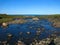 Background blurred view landscape shallow river flowing over the plateau and flowing into the Barents Sea