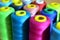 Background of bobbins with multicolored threads for sewing. Needlework, sewing and tailoring concept.