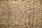 Background braided algae hyacinth yellow-brown with a beautiful weave in the form of braids. Backgrounds, design