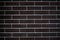 Background of a brick dark wall, tile texture with a smooth pattern.