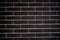 Background of a brick dark wall, tile texture with a smooth pattern.