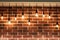 Background of brick wall and decorative incandescent lamps