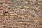 Background, brick wall made old German red burnt brick with traces bullets and shrapnel after World War II.