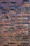 Background, brick wall made old German red burnt brick with traces bullets and shrapnel after World War II.