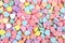 Background of brightly colored candy hearts for Valentine`s Day