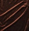 Background of brown velor fabric. Modern upholstered velvet furniture. Creative vintage background