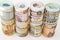 Background of bundles and rolls of Egyptian money currency cash banknotes rolled up with rubber bands in different bill values of