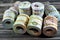 Background of bundles and rolls of Egyptian money currency cash banknotes rolled up with rubber bands in different bill values of