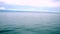 Background of the calm sea with island at far away. view from ferry boat moving.